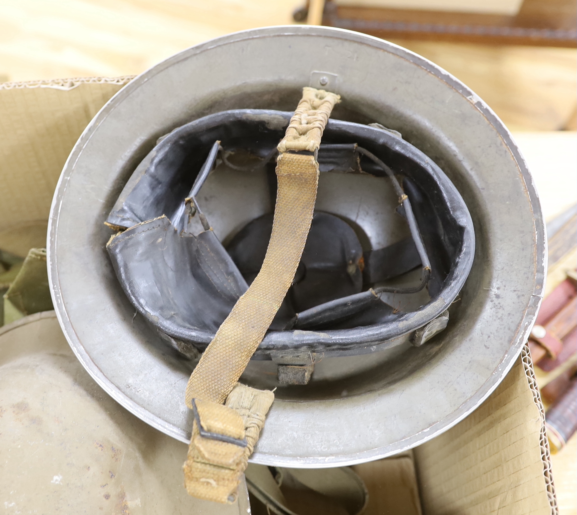 Six military etc. tin helmets. Including an example, painted as an Air Raid Warden’s helmet, with other items, including a military shoulder bag etc.